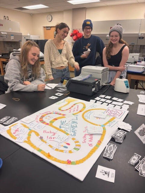 Students playing board game in 250.